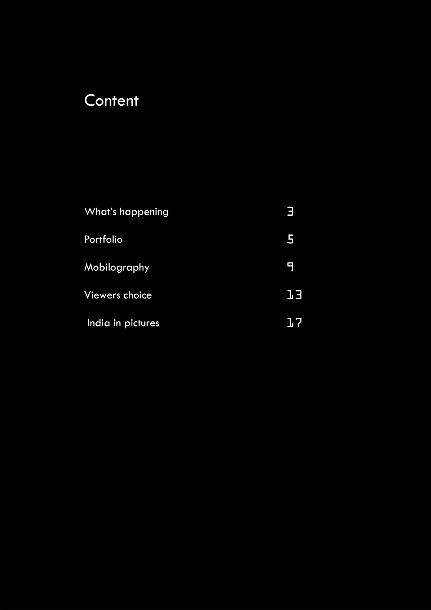 Magazine contents page with white typography on a black background
