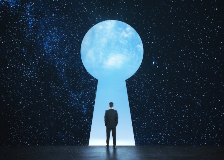 man entering a giant key hole in the sky - the inside of the key hole shows day time while the rest of the sky shows a night time sky full of stars