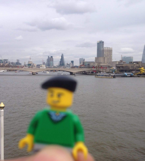Photo of a blurred lego figure with the London skyline in focus over the river Thames